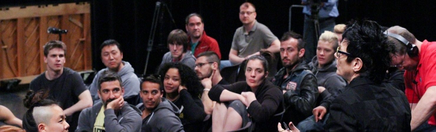 Image of Elizabeth Streb in an auditorium providing feedback to students