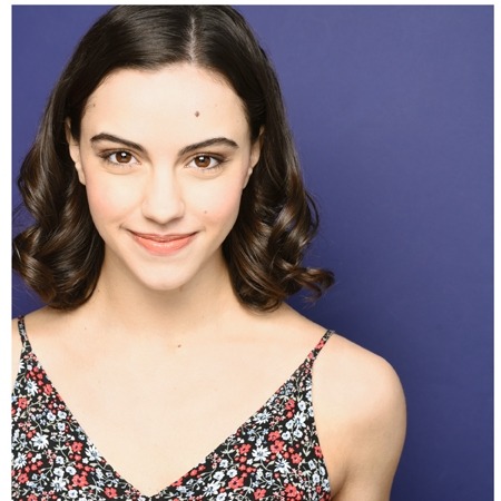 Photo of Katie Pohlman - dark hair with a patterned dress